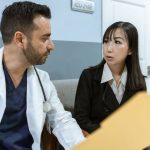 Médecin et femme en conversation dans un cabinet médical avec un dossier sur la table